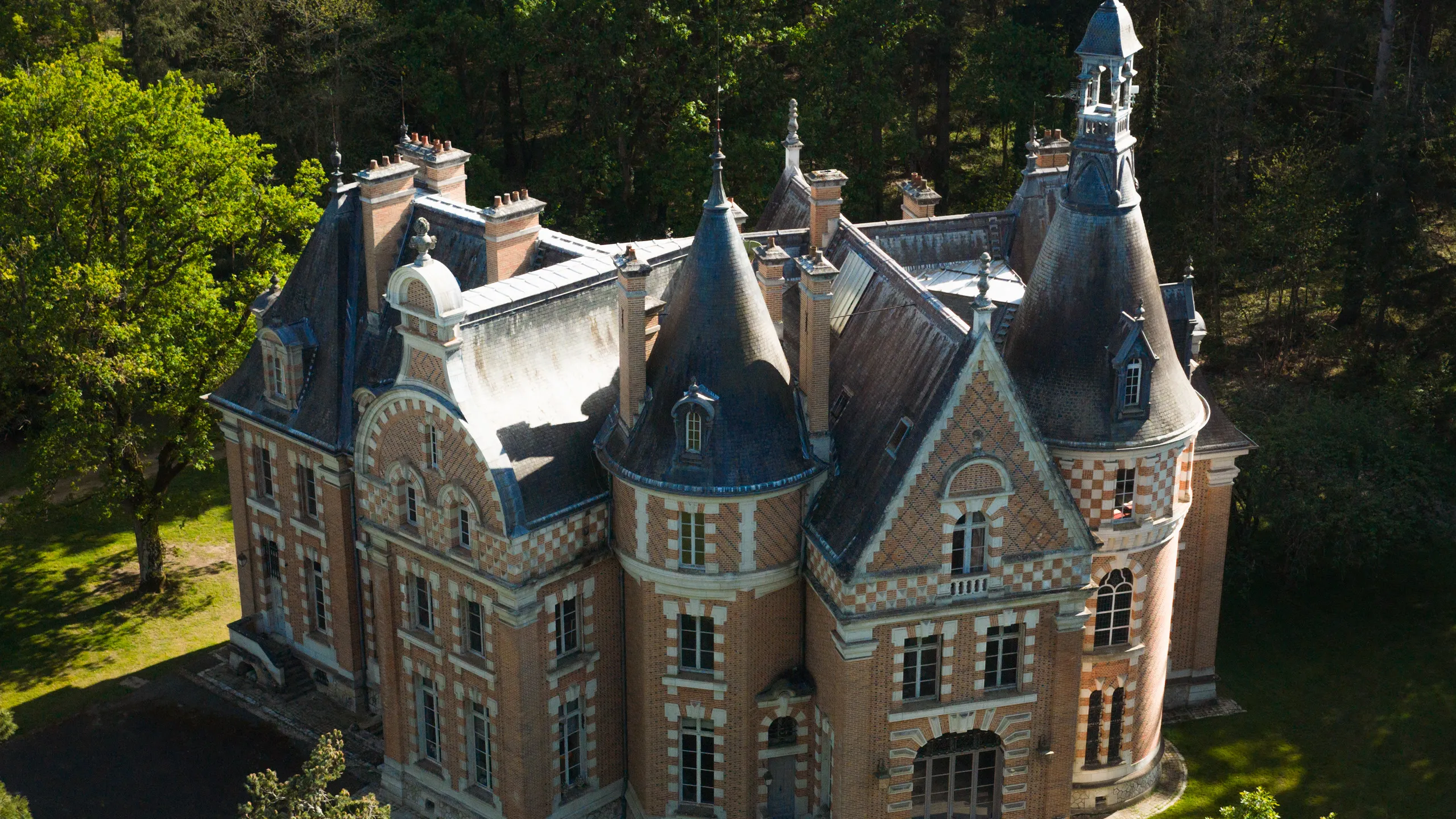 Drone shot of the château at Les Bordes Estate, surrounded by forest